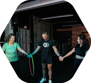 Clients and a coach working together on the training floor