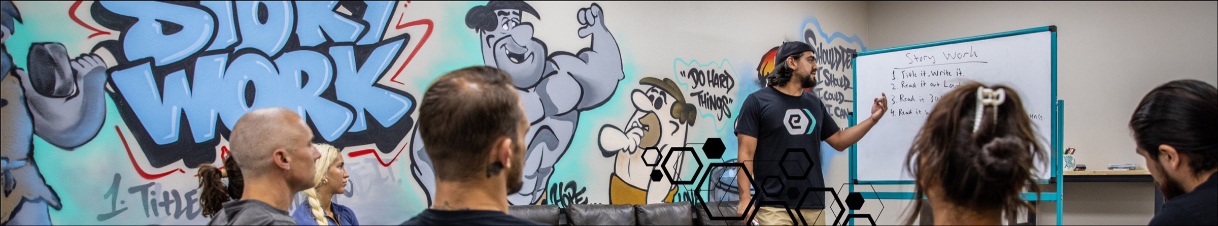 A Story Work session in front of the e-motion wellness® mural